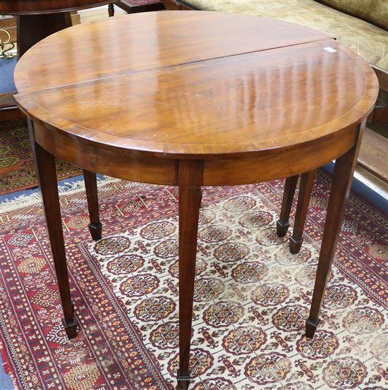 A pair of mahogany demi-lune side tables width 91cm